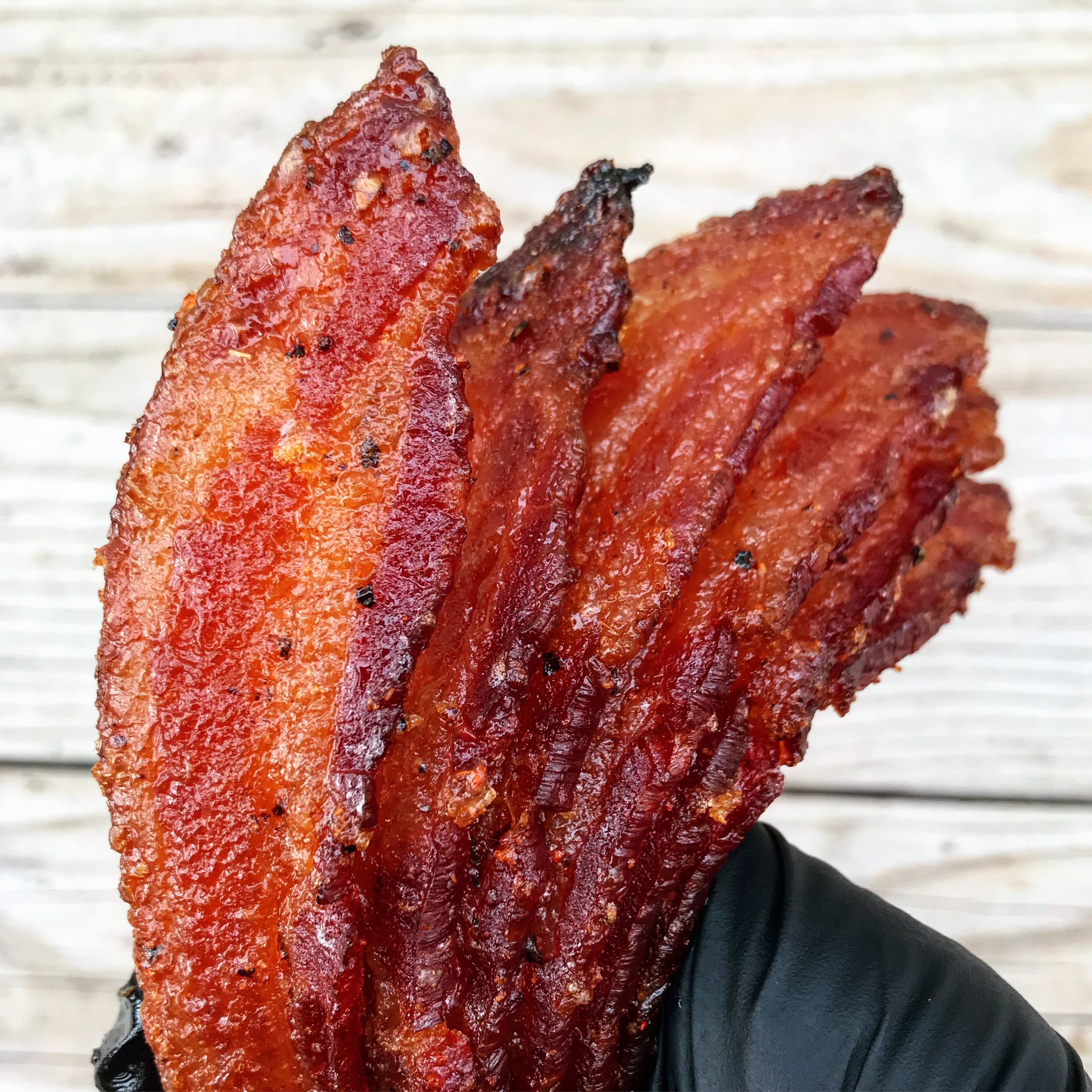 Smoked bacon candy in hand.